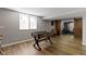 Basement view showing window, foosball table, and open doorway to exercise equipment behind sliding barn doors at 15385 Ellington Dr, Fishers, IN 46040