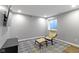 Finished basement space with chair, ottoman, small TV, and a patterned area rug at 15385 Ellington Dr, Fishers, IN 46040