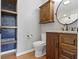 Tasteful bathroom features vanity with granite countertop, hexagon-tiled accent wall and dark wood cabinet at 15385 Ellington Dr, Fishers, IN 46040
