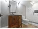 Bathroom featuring a wood vanity, black faucet, toilet, walk in shower with white subway tile and black hardware at 15385 Ellington Dr, Fishers, IN 46040