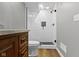 Bathroom featuring a wood vanity, black faucet, toilet, walk in shower with white subway tile and black hardware at 15385 Ellington Dr, Fishers, IN 46040