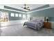 A spacious bedroom with tray ceiling, fan and plenty of natural light at 15385 Ellington Dr, Fishers, IN 46040