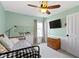 Bedroom features soft green walls, a ceiling fan, and a window with natural light at 15385 Ellington Dr, Fishers, IN 46040