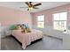 A pink bedroom with a comfortable bed, plush carpet, and bright natural light at 15385 Ellington Dr, Fishers, IN 46040