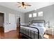 Tranquil bedroom with hardwood floors, panel moulding, and view to ensuite bathroom at 15385 Ellington Dr, Fishers, IN 46040
