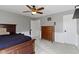 A cozy bedroom featuring a ceiling fan, gray walls, carpeted floors, and a wooden dresser at 15385 Ellington Dr, Fishers, IN 46040