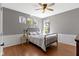 Charming bedroom with hardwood floors, panel moulding, and natural light from multiple windows at 15385 Ellington Dr, Fishers, IN 46040