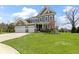Inviting two-story home with lush green lawn, three car garage, and well-maintained landscaping at 15385 Ellington Dr, Fishers, IN 46040