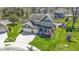 A beautiful two-story home featuring a three-car garage, well-kept lawn, and a charming front porch at 15385 Ellington Dr, Fishers, IN 46040