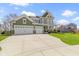 Attractive two-story home with a three-car garage, lush lawn, and inviting front porch at 15385 Ellington Dr, Fishers, IN 46040