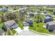 Aerial view of a two-story home with a well-manicured lawn, mature trees, and a play area at 15385 Ellington Dr, Fishers, IN 46040