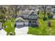 A two-story home with a three-car garage, front porch seating, and a lush, green lawn in a Gathering-friendly neighborhood at 15385 Ellington Dr, Fishers, IN 46040