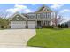 Charming two-story home with a well-manicured lawn, attached three car garage and lovely landscaping at 15385 Ellington Dr, Fishers, IN 46040