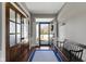 Bright foyer with hardwood floors, decorative rug, a wooden bench and a glass paneled front door at 15385 Ellington Dr, Fishers, IN 46040