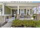 Welcoming front porch features classic columns, an inviting wreath, and comfortable seating area at 15385 Ellington Dr, Fishers, IN 46040