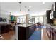 Spacious kitchen boasts a large island, sleek appliances, and seamless flow into the dining and living areas at 15385 Ellington Dr, Fishers, IN 46040