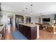 Open-concept kitchen featuring a large island with seating, open to the living room at 15385 Ellington Dr, Fishers, IN 46040