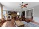 Inviting living room with cozy leather seating, hardwood floors, and adjacent eat-in kitchen at 15385 Ellington Dr, Fishers, IN 46040