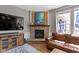 Cozy living room featuring a brick fireplace and views to the outdoor deck at 15385 Ellington Dr, Fishers, IN 46040