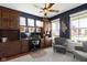 Office with custom built-ins, ceiling fan, hardwood floors, area rug, and natural light at 15385 Ellington Dr, Fishers, IN 46040