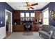 Office with custom built-ins, ceiling fan, hardwood floors, area rug and comfortable sitting area at 15385 Ellington Dr, Fishers, IN 46040