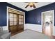 Office with custom built-ins, hardwood floors, area rug and a view into the dining room at 15385 Ellington Dr, Fishers, IN 46040