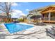Relaxing in-ground pool area, complete with stylish lounge furniture, outdoor pavilion, and privacy fence at 15385 Ellington Dr, Fishers, IN 46040