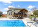 Beautiful backyard with a stunning in-ground pool, lounging area, and lush green landscaping at 15385 Ellington Dr, Fishers, IN 46040