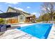 Stunning backyard oasis with a refreshing blue in-ground pool and inviting outdoor spaces at 15385 Ellington Dr, Fishers, IN 46040