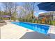 Sparkling blue in-ground pool with a spacious patio and lounge seating for relaxing days at 15385 Ellington Dr, Fishers, IN 46040