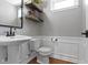 Classic powder room featuring a pedestal sink, floating wood shelves, and wood-look floor at 15385 Ellington Dr, Fishers, IN 46040