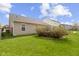 Backyard view with manicured lawn, residential fence, and rear house elevation at 15501 Landsbrook E Run, Noblesville, IN 46060