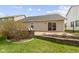 Manicured lawn and retaining wall featuring a patio with chairs, and various plants at 15501 Landsbrook E Run, Noblesville, IN 46060