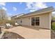 View of backyard patio, attached to the house via a sliding glass door, and furnished with seating at 15501 Landsbrook E Run, Noblesville, IN 46060