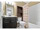 This bathroom features a shower with a colorful curtain, a black vanity, and a medicine cabinet at 15501 Landsbrook E Run, Noblesville, IN 46060