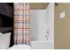 This bathroom features a toilet, a shower with a colorful curtain, and neutral colored walls at 15501 Landsbrook E Run, Noblesville, IN 46060