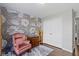 The bedroom displays a decorative wallpaper, wood floors, an accent chair, and a cabinet at 15501 Landsbrook E Run, Noblesville, IN 46060