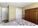 Cozy bedroom features a double door closet, a football patterned blanket and neutral colored walls at 15501 Landsbrook E Run, Noblesville, IN 46060