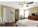This bedroom has a ceiling fan, neutral colored walls, and wood floors at 15501 Landsbrook E Run, Noblesville, IN 46060