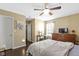 This bedroom has a ceiling fan, neutral colored walls, and wood floors at 15501 Landsbrook E Run, Noblesville, IN 46060