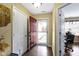 Inviting entryway with a brown front door, wood-look tile flooring, and adjacent home office at 15501 Landsbrook E Run, Noblesville, IN 46060