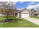 Well-kept home with a two-car garage, brick facade, tidy landscaping, and a green lawn at 15501 Landsbrook E Run, Noblesville, IN 46060