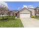 Charming single-Gathering home with brick and siding, a two-car garage, and a well-manicured front yard at 15501 Landsbrook E Run, Noblesville, IN 46060