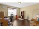 Comfortable home office space with a large window, ample desk space, and hardwood floors at 15501 Landsbrook E Run, Noblesville, IN 46060