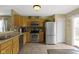 Well-equipped kitchen with stainless steel appliances, tiled floors, and wood cabinets at 15501 Landsbrook E Run, Noblesville, IN 46060