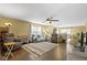 Spacious living room featuring a ceiling fan, hardwood floors, and open to the dining area at 15501 Landsbrook E Run, Noblesville, IN 46060