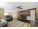 Inviting living room showcasing hardwood floors, a decorative wood wall, and a ceiling fan at 15501 Landsbrook E Run, Noblesville, IN 46060