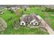 Aerial view of a white brick home with pool, sport court and extensive manicured lawn at 1583 E Osprey Dr, Greenfield, IN 46140