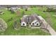 Aerial view of a white brick home with pool, sport court and extensive manicured lawn at 1583 E Osprey Dr, Greenfield, IN 46140