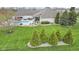 Backyard aerial view featuring well manicured lawn, pool, and a patio area with plenty of seating at 1583 E Osprey Dr, Greenfield, IN 46140